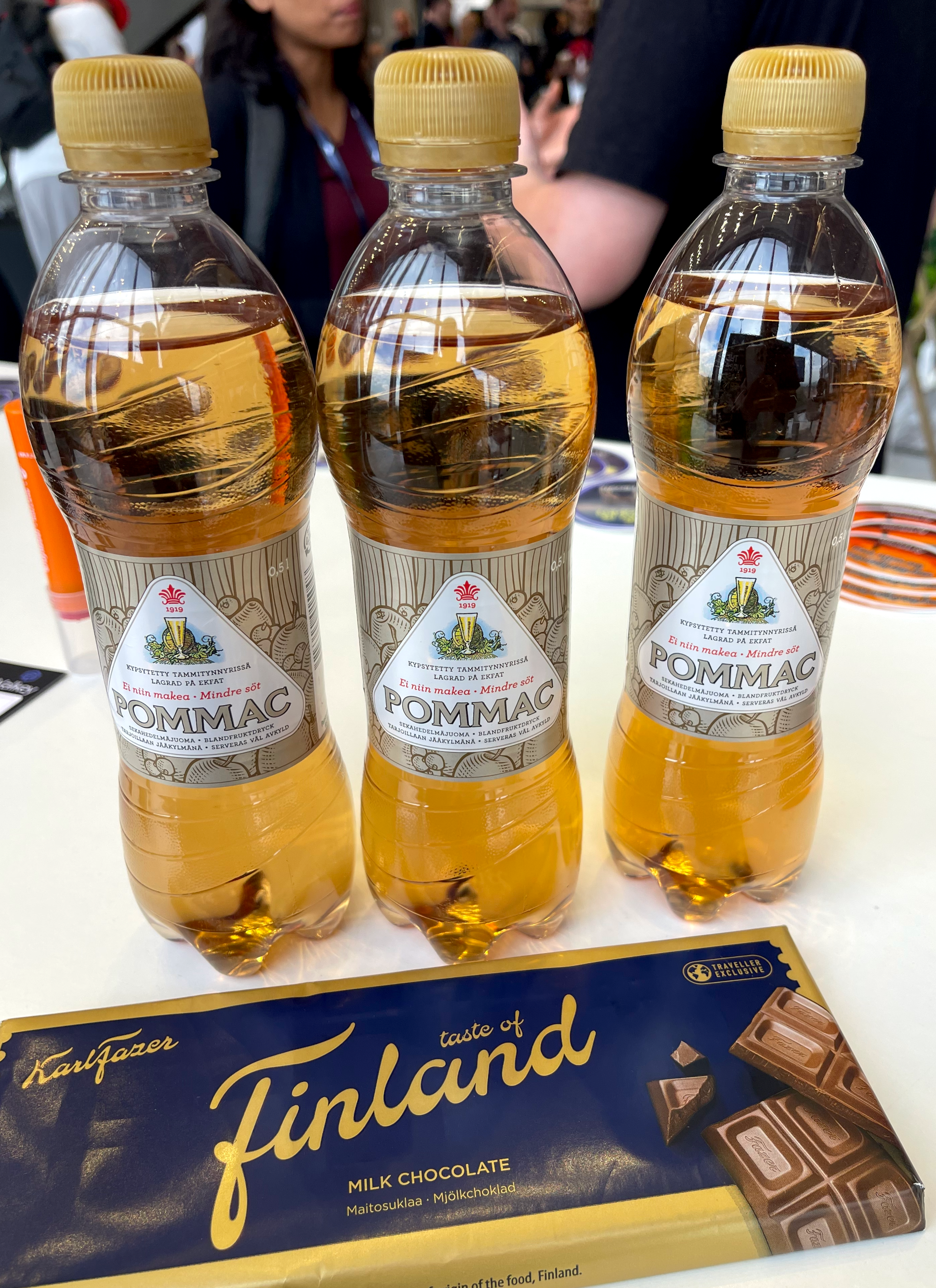Three bottle of Pommac soda and a bar of Finnish chocolate
