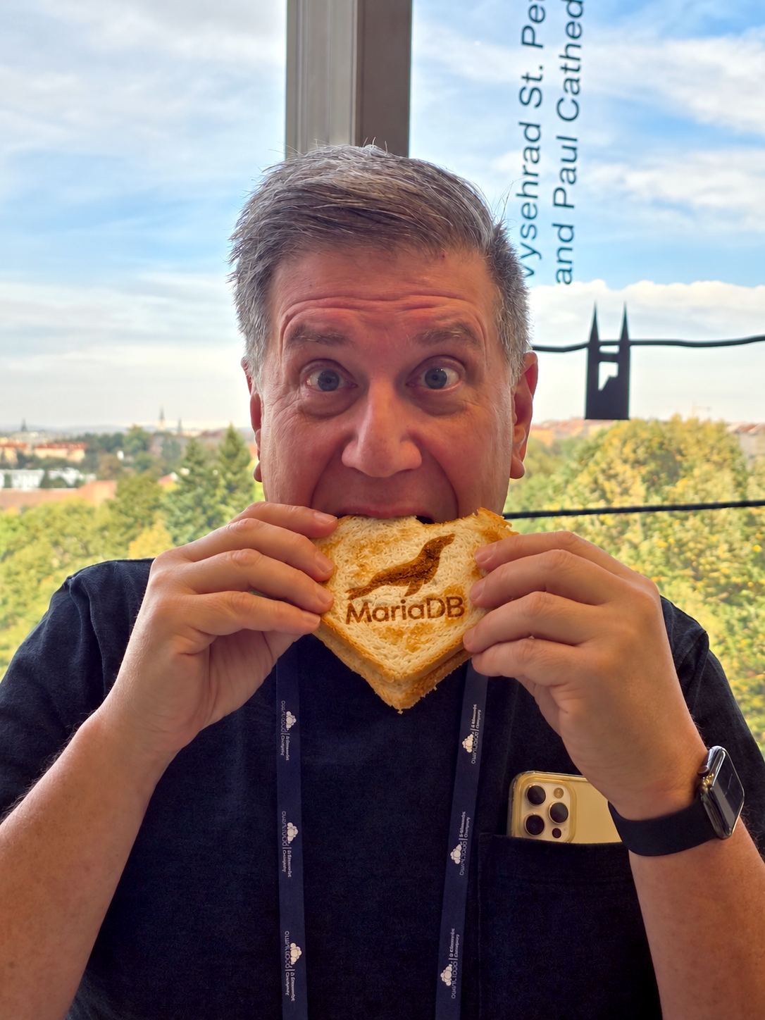 Me eating a sandwich with the MariaDB Logo added via AI